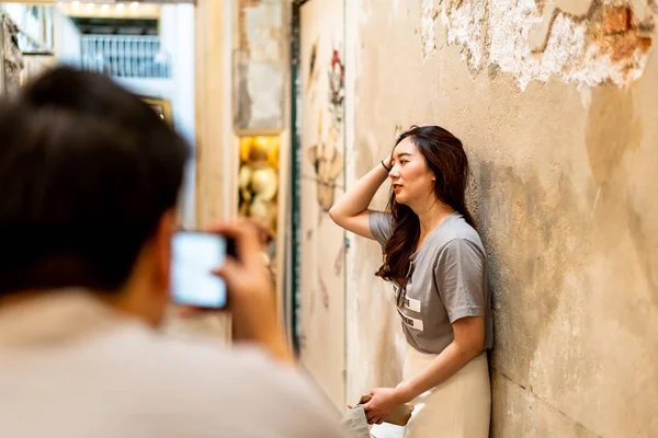 Happy Asian couple taking a photo — Stock Photo, Image