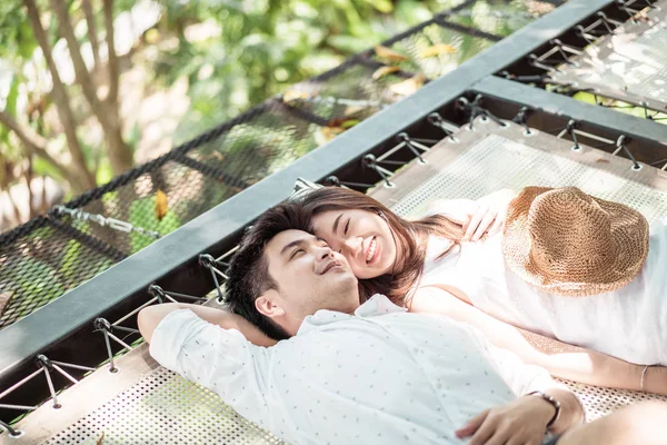 Young happy Asian couple in love on cradle balcony — Stock Photo, Image
