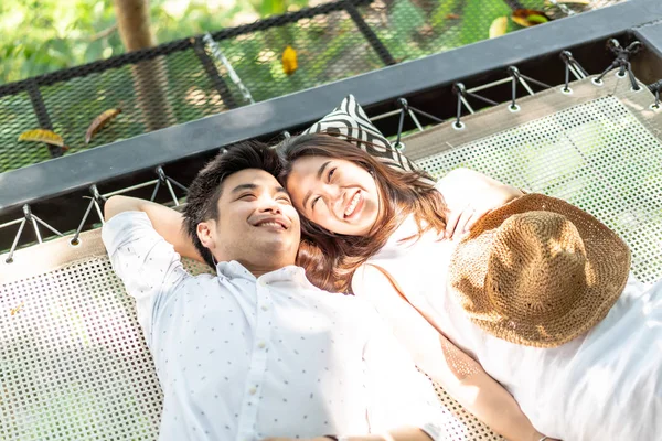 Young happy Asian couple in love on cradle balcony