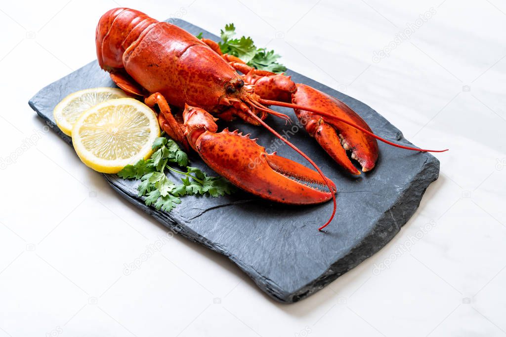lobster with vegetable and lemon on black slate plate