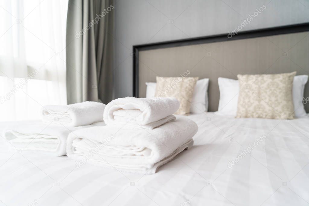 white towel decoration on bed 
