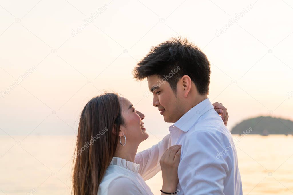 Happy couple going honeymoon travel on tropical sand beach in su