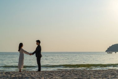 Mutlu çift balayı gidiş tropikal kum plajı üzerinde su içinde seyahat.