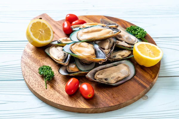 Fresh mussel on wood board — Stock Photo, Image
