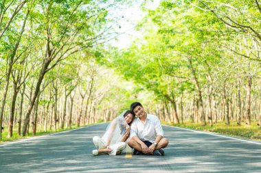 Ağaç arch ile yolda aşık mutlu Asya çift