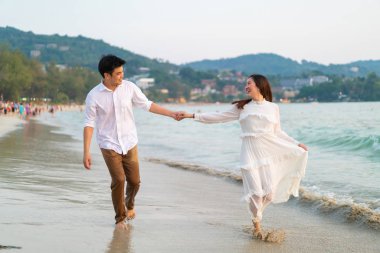 Mutlu çift balayı gidiş tropikal kum plajı üzerinde su içinde seyahat.