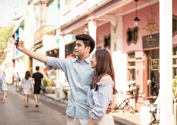 Happy young Asian couple in love having a good time