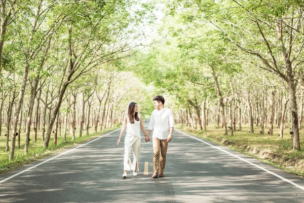 Heureux asiatique couple dans l'amour sur la route avec arbre arc — Photo