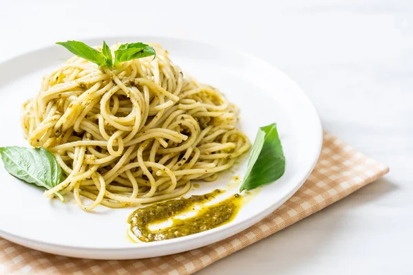 Spaghetti z sosem pesto, oliwa z oliwek i liści bazylii. — Zdjęcie stockowe