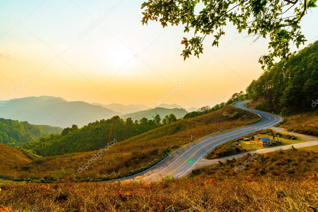 beautiful sunset sky with layer mountain and road