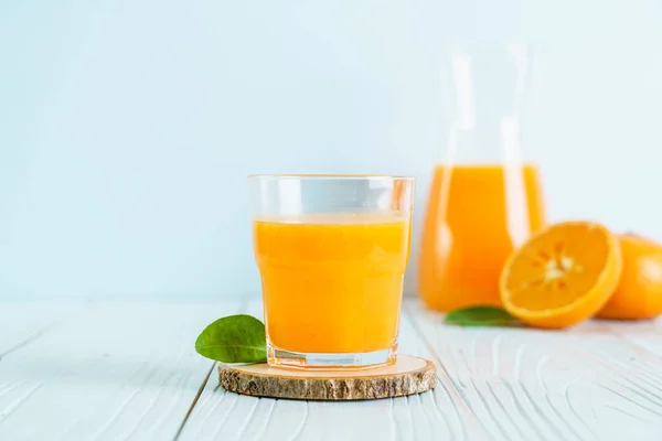 Świeży sok pomarańczowy na tle drewna — Zdjęcie stockowe