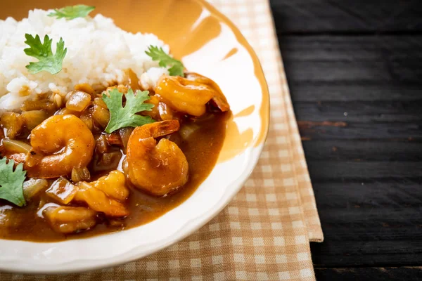 Shrimps in curry sauce on rice — Stock Photo, Image