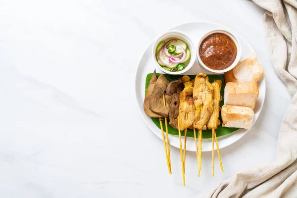Pork Satay with your Peanut Sauce  and pickles which are cucumbe — Stock Photo, Image
