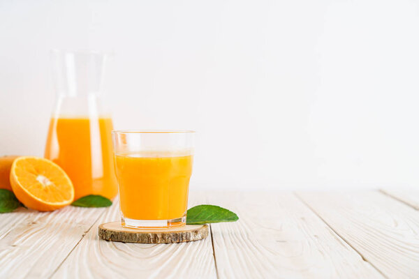 Fresh orange juice on wood background