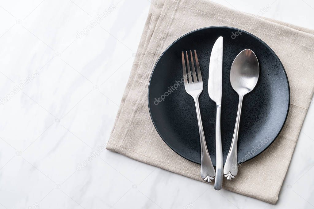 empty plate spoon fork and knife