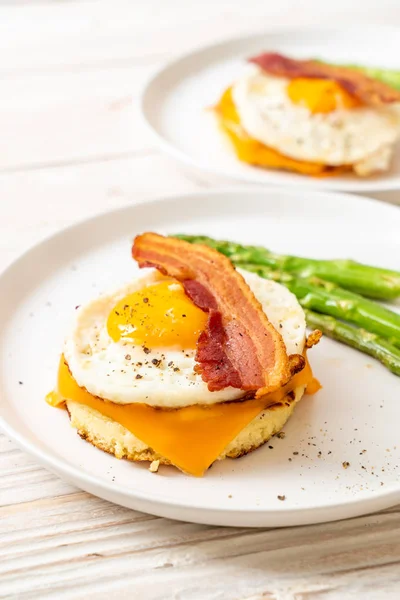 fried egg with bacon and cheese on pancake