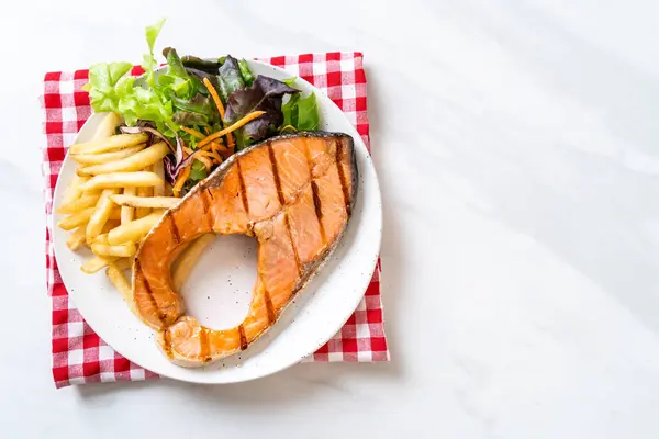 Filet de steak de saumon grillé aux légumes et frites — Photo