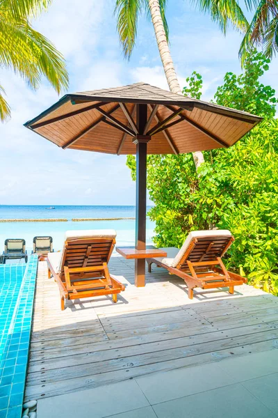 Пляжное кресло с бассейном и морским фоном на Мальдивах — стоковое фото