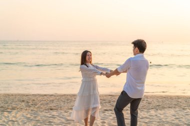 Mutlu çift balayı gidiş tropikal kum plajı üzerinde su içinde seyahat.