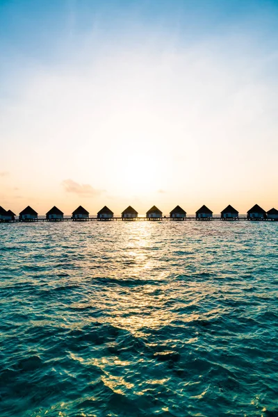 Beautiful tropical sunset over Maldives island with water bungal — Stock Photo, Image