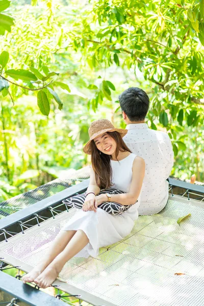 Young happy Asian couple in love on cradle balcony