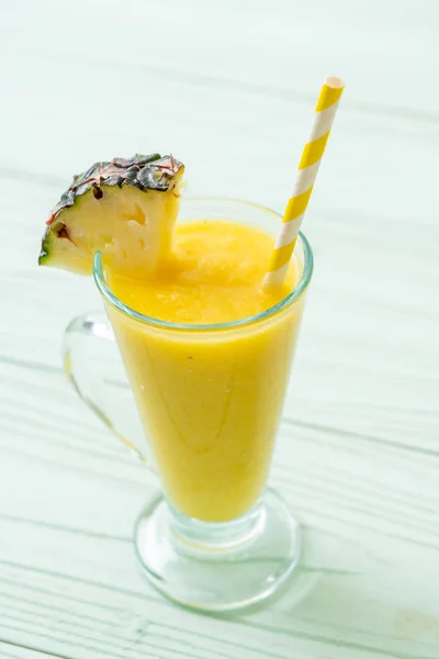 Fresh pineapple smoothie glass on wood table — Stock Photo, Image