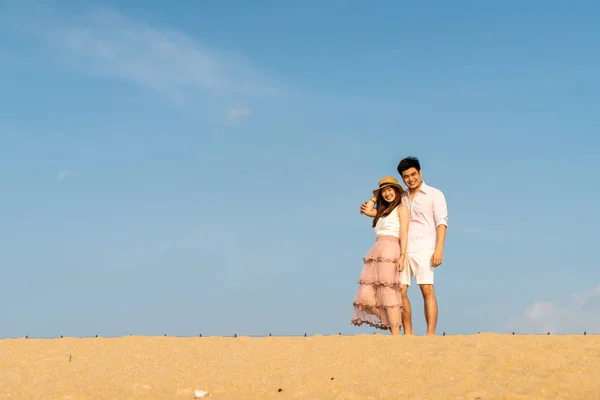 Happy Asian couple in love with blue sky