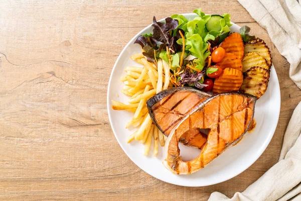 Filet de steak de saumon grillé aux légumes et frites — Photo