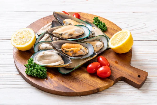 Fresh mussel on wood board — Stock Photo, Image