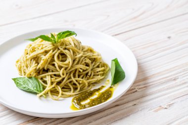 Spagetti pesto sos, zeytin yağı ve fesleğen yaprakları ile.