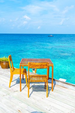 ahşap masa ve koltuk Maldivler deniz manzarası arka plan ile