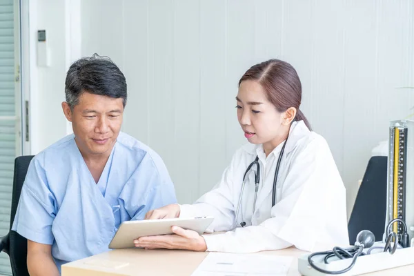 Азиатский старший пациент на консультации с врачом — стоковое фото
