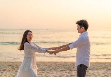 Mutlu çift balayı gidiş tropikal kum plajı üzerinde su içinde seyahat.