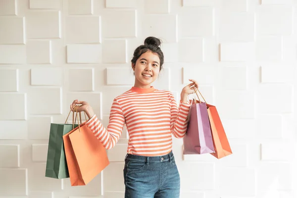 Asian woman holding shopping bags