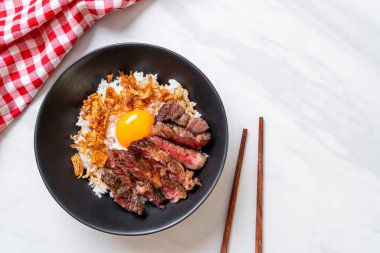 yumurta ile tepesinde pirinç kase dilimlenmiş sığır eti