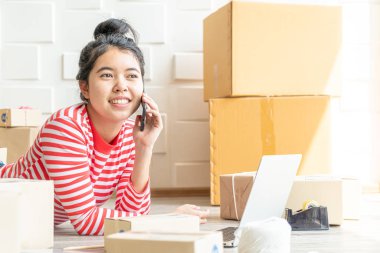 Asya kadın iş sahibi çalışan evde ambalaj kutusu ile w