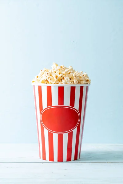 Movie Popcorn in bucket on wood background