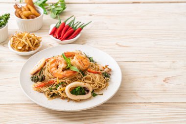 Fesleğenli, biberli, karidesli ve kalamarlı Çin eriştesi. Asya usulü.