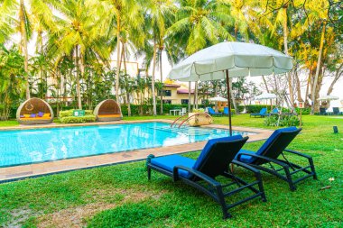 Otel havuzunda yüzme havuzu ve şemsiyesi