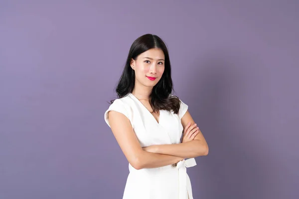 Young asian business woman with happy face on purple background