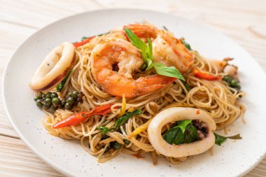 Fesleğenli, biberli, karidesli ve kalamarlı Çin eriştesi. Asya usulü.