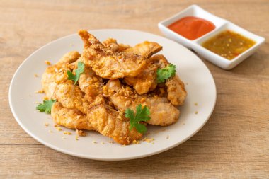 Tabakta sarımsaklı kızarmış balık.