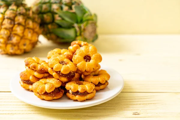 flower biscuits with pineapple jam on wood background