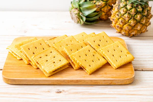 cheese biscuits with pineapple jam on wood background