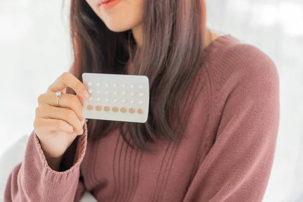 beautiful Asian women holding Birth control pill