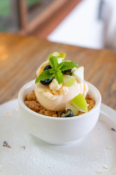 vanilla iced-cream with fresh apple and apple crumble in cafe and restaurant