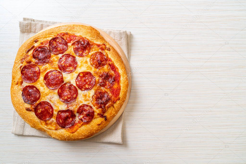 pepperoni pizza on wood tray - Italian food style