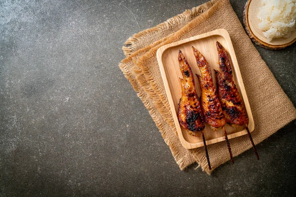 grilled or barbecue chicken wings skewer with sticky rice