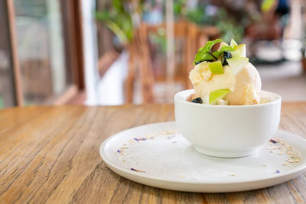 vanilla iced-cream with fresh apple and apple crumble in cafe and restaurant