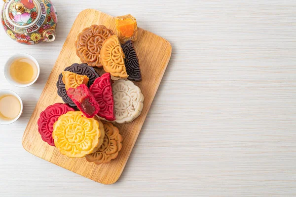 colourful Chinese moon cake with mixed flavour on wood plate